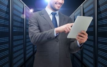 business, people and technology concept - happy smiling businessman in suit holding tablet pc computer over futuristic server room background. businessman with tablet pc over server room