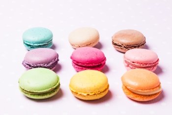 Colorful macaroons - french dessert over pink polka dot napkin. The Colorful macaroons 