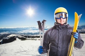 Ski slope in High Tatras mountains on the background and skier portait with equipment. Ski slope and skier