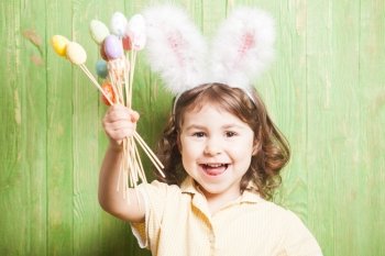 Girl with bunny ears and little eggs. Easter celebration. Girl with bunny ears 