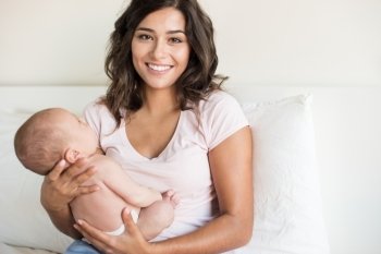 Lovely mother holding newborn baby in arms