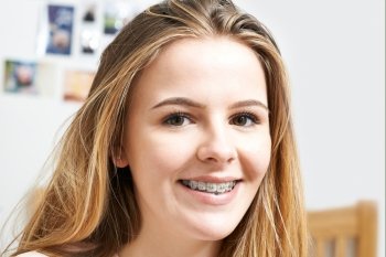Portrait Of Smiling Teenage Girl Wearing Dental Braces