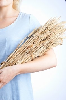 Close Up Of Woman Holding Bundle Of Wheat