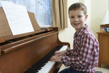 Portrait Of Young Boy Playing Piano At Home