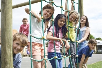 Portrait Of School Pupils Playing On Climbing Frame