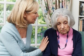 Mature Female Friend Comforting Unhappy Senior Woman