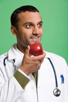 Doctor eating an apple