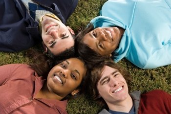 Four students lying down outdoors