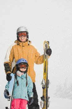 Father and daughter preparing to ski