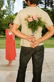 Man surprising wife with flowers