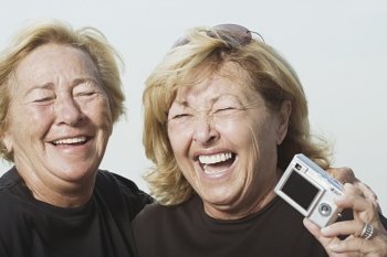 Laughing women with digital camera