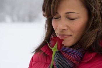 Mature woman smelling a rose