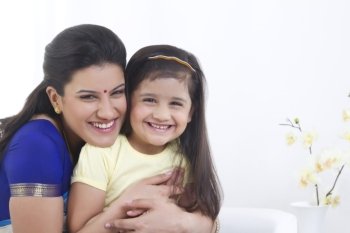 Portrait of mother and daughter smiling