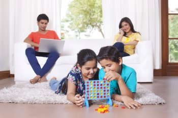 Kids playing while parents sit on sofa