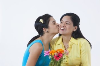 Girl kissing mother on cheek