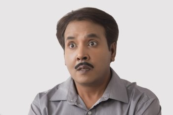 Close up portrait of a surprised man on a white background.