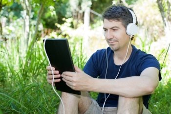 casual man working with a tablet pc, outdoor