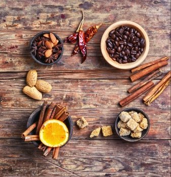 Seasoning for coffee from cinnamon,star anise and almonds on the vintage background