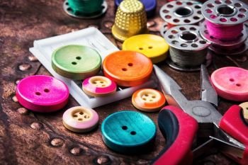 Retro buttons and threads. Domestic collection of colourful sewing retro buttons and threads
