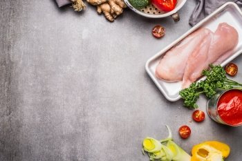 Raw chicken breast fillets with various vegetables ingredients for tasty diet cooking, preparation on  concrete background, top view, border. Healthy food and Sports nutrition concept