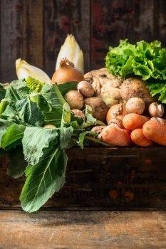 Organic vegetables box on old wooden background