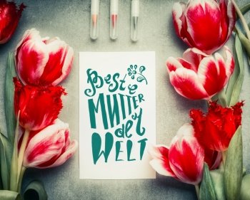 Mothers Day Greeting card with text lettering in german Beste Mutter der Welt , pencil  and tulips flowers, top view, frame