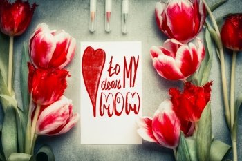 Mothers Day Greeting card with text lettering To my dear mom, pencil  and tulips flowers, top view, frame