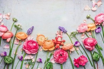 Border of Various beautiful garden flowers on shabby chic background, frame, top view, floral border