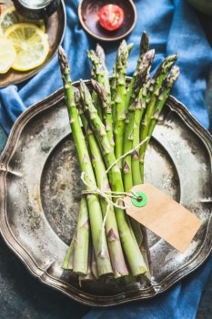 Asparagus bunch with blank paper label , top view, close up, copy space