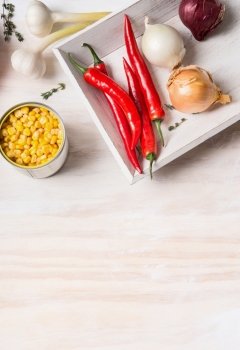 Canned corn and cooking ingredients  on white rustic background, top view, place for text. Healthy , clean food or vegetarian cooking and eating concept
