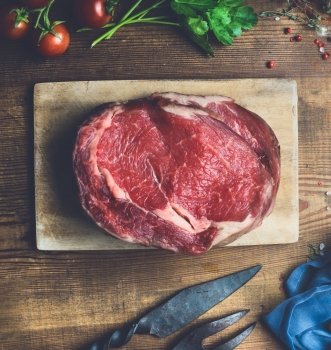 Raw beef steaks  on wooden kitchen table background, top view