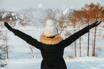 Girl Throwing Snow In Air During Winter