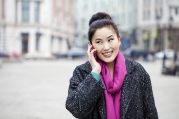 Asian beautiful girl calling by phone in spring street