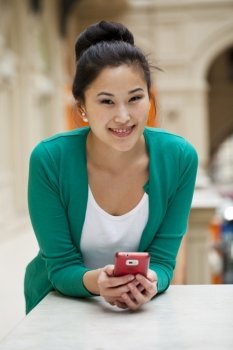 Young beautiful asian holding a cell phone