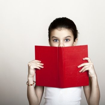 Little girl holding red book, studio on white background