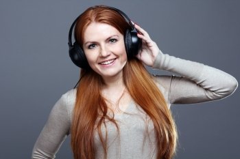 Happy young woman listening to music 