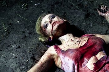 Bloody dead woman lying on the ground