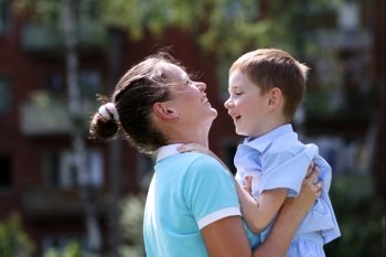 Happy mother and her little son outdoors session 