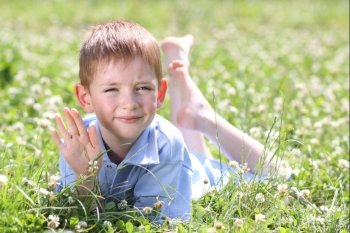 5 years old child lying on the grass. 