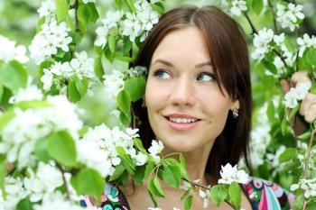 Portrait of beautiful woman in spring blossom 