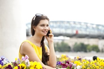 Young beautiful woman talking on cell phone 