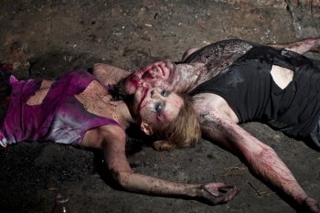 Couple of bloody man and woman lying on the ground