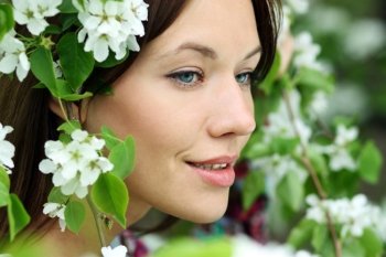 Portrait of beautiful woman in spring blossom 