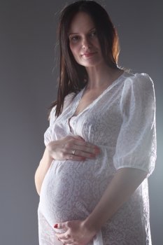 pregnant female holding her breasts 