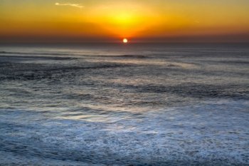 sunset on the ocean in portugal ilustrating the dimension of the ocean