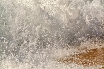 water breaking on sand background