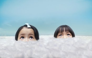 Two little girl looking above through over clouds , concept about dreams of future.