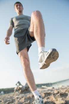Legs View Of A Man  Jogging Outdoor on the Beach