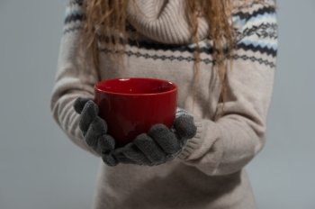 Unrecognizable Woman holding red tea cup