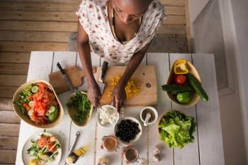 Young African Woman Cooking. Healthy Food - Vegetable Salad. Diet. Dieting Concept. Healthy Lifestyle. Cooking At Home. Prepare Food. Top View